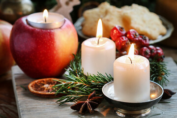 Beautiful candles and other traditional Christmas decorations on the table.