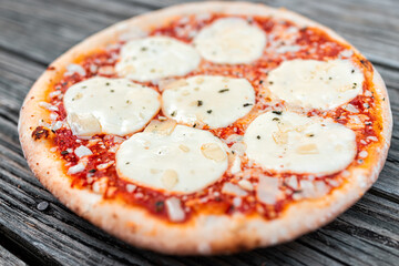 Traditional Italian baked hot pizza from Italy closeup with melted mozzarella provolone cheese...