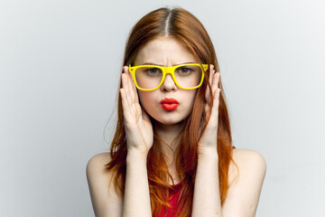 pretty woman yellow glasses and red lips fashion light background