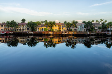 Hollywood beach in north Miami, Florida with Intracoastal water canal Stranahan river and view of waterfront property modern mansions villas houses with palm trees reflection at sunset - obrazy, fototapety, plakaty
