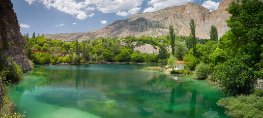 Small and beautiful turquoise lake. The lake between the mountains.