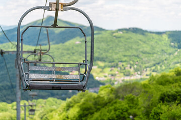 Sugar Mountain ski resort town in summer with closeup of ski chair lift slope and green lush...