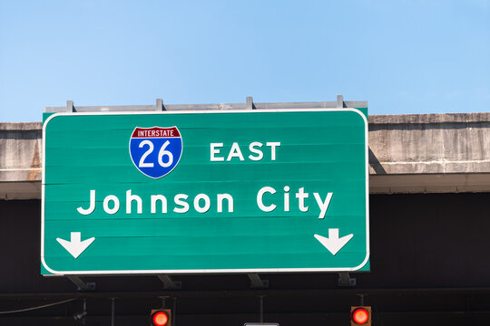 Johnson City, USA road street interstate highway green sign for i26 26 east to Johnson City in Tennessee with text isolated closeup and blue sky