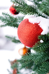 Snow-covered outdoor decorated Christmas tree close-up.New Year and Christmas concept.Selective focus.
