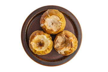 baked apples on a ceramic brown plate top view