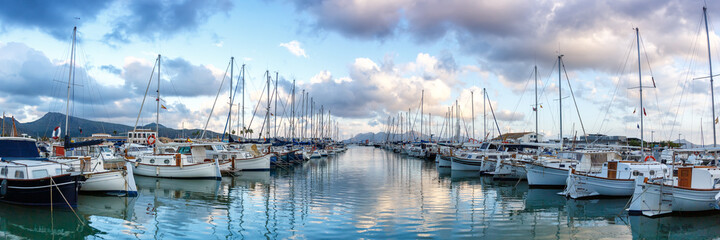 Port de Pollenca marina with sailing boats sailboats on Mallorca travel traveling holidays vacation panorama in Spain