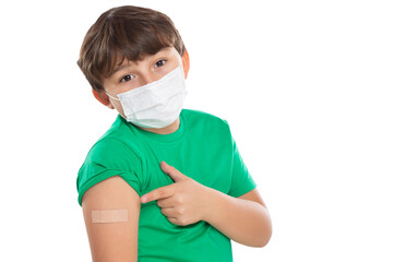 Child kid pointing on plaster after Coronavirus vaccination wearing face mask against Corona Virus COVID-19 Covid isolated on white