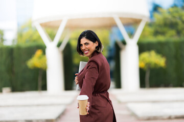Successful smiling business woman with a cup of coffee