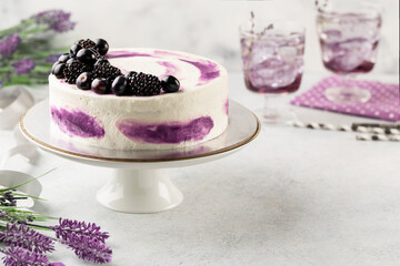 Beautiful tasty cake with white cream and blueberries on cake stand