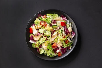 salad with chicken, cherry tomatoes and cucumber, pepper