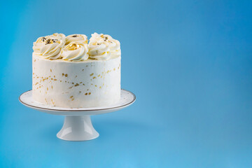 Beautiful tasty white cake with white cream; on cake stand