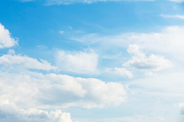 Naklejka na ściany i meble Blue sky background with fluffy cumulus clouds, atmospheric panorama
