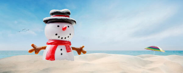 Concept - happy snowman on the beach on sunny Christmas day afternoon