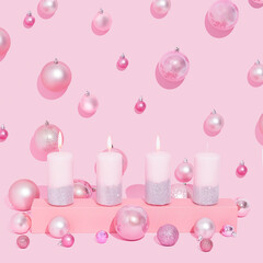 Pink Advent Candles in a row on a pastel pink background. Christmas balls.  Third candle lit, symbolizes joy.