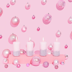 Pink Advent Candles in a row on a pastel pink background. Christmas balls.  Fourth candle lit, symbolizes peace.