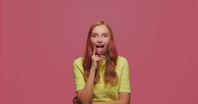 Funny humorous young girl grimacing, fooling around show tongue, comical goofy facial expression, laughing