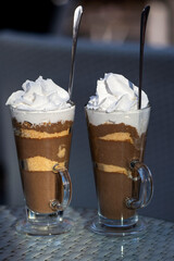 Two hot chocolates with cookies and double cream with sugar. Cold afternoon with hot chocolate and good company.