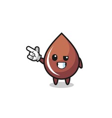 chocolate drop mascot pointing top left