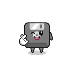 floppy disk character doing Korean finger heart