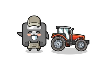 the floppy disk farmer mascot standing beside a tractor