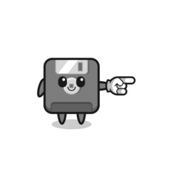 floppy disk mascot with pointing right gesture