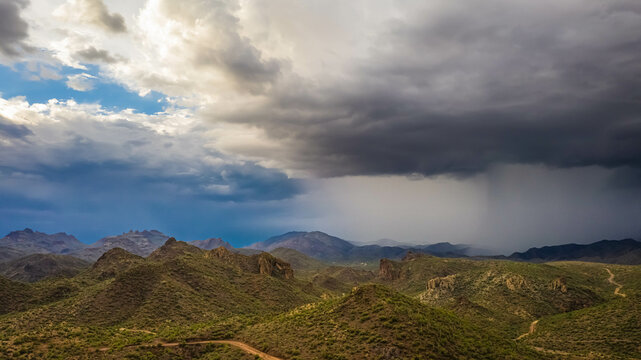 Aerial drone image of a monsoon over the Sonoran Desert of Arizona with rugged terrain.