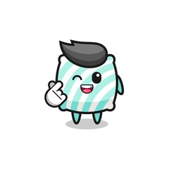 pillow character doing Korean finger heart