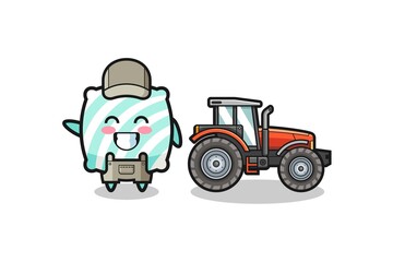 the pillow farmer mascot standing beside a tractor
