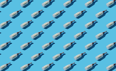 Pattern of champagne bottles on blue pastel background