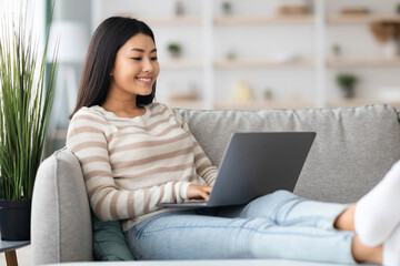Freelance Concept. Happy Young Korean Woman Using Laptop At Home