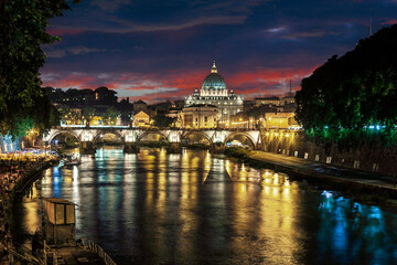Fototapeta na wymiar Night view at St. Peter's cathedral in Rome with reflection on Tiber river