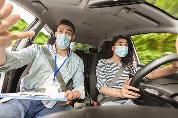 Brunette woman learning parking at driving school while pandemic