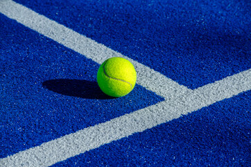 Ball next to the lines on a paddle tennis court