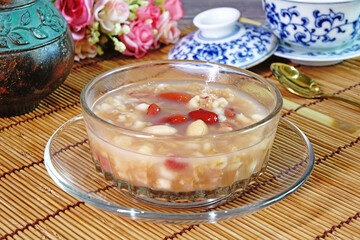 Rice congee made with red beans, lotus seeds, longan, red dates, and nuts. Sweet congee, Selective focus