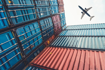 Freight airplane flying above overseas shipping container . Logistics supply chain management and...