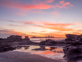 Colourful Seaside Sunrise with Cloud Reflections