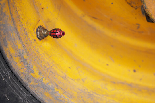 Valve Cap In The Shape Of A Red Grenade.