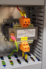 Small transformer changing voltage from 230V to 24V in the switchboard.