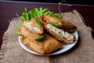 Martabak Tahu or Tofu Martabak, a spicy omelette pancake filled with bits of vegetables, leek, celery leaves, tofu and egg, Indonesian traditional food