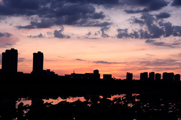 The river in the city Park reflects the city skyline against a beautiful and spectacular sunset backdrop.