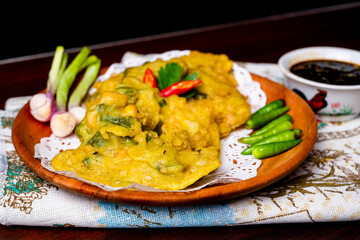 Tempe Mendoan, with chili, indonesian traditional food, made from tempeh covered in flour batter with a mixture of sliced leeks and spice