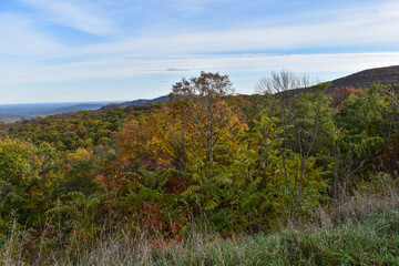 Shenandoah National Park, Virginia, USA - November 3, 2021: Mountain Scenery With Beautiful Fall Trees in the Foreground and a Bright Blue Sky in the Background