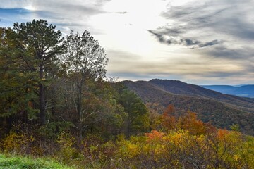 Shenandoah National Park, Virginia, USA - November 3, 2021: Mountain Scenery With Beautiful Fall Trees in the Foreground and a Bright Blue Sky in the Background