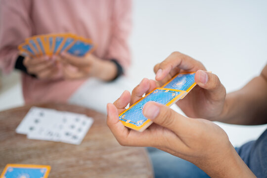 Close up of a hand shuffling cards while playing cards