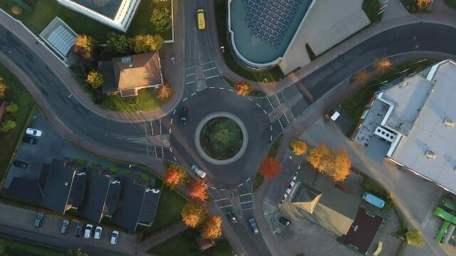 Traffic Driving At Roundabout In Friesoythe Town In Cloppenburg, Lower Saxony, Germany. - aerial ascend