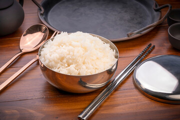 Korean steamed rice in silver cup ready to eat, Korean style.