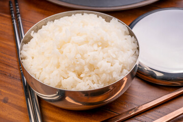 Korean steamed rice in silver cup ready to eat, Korean style.