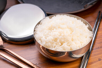 Korean steamed rice in silver cup ready to eat, Korean style.