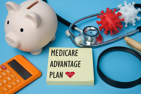 A Picture Of Medicare Advantage Plan On Notepad, Stethoscope, Coronavirus 3D Printing, Piggy Bank And Other Prop Insight.