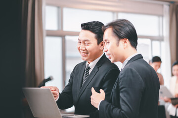 Fototapeta premium Asian businessman using laptop for working online at workplace